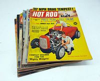 Stack of ten vintage Hot Rod magazines showing colorful cover featuring a red hot rod car and two men