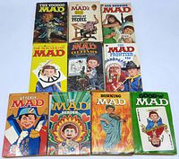 Top view showing front covers of 10 vintage Mad Magazine paperback collections with colorful illustrated covers featuring Alfred E. Neuman and various themes.