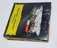 Stack of classical LP vinyl records showing top album Schwanensee (Swan Lake) ballet, Berliner Symphonie-Orchester, Deutsche Grammophon label.