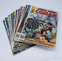 Stack of 13 vintage Marvel Savage Sword of Conan magazines showing front covers.