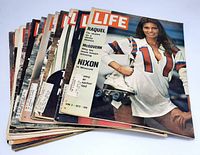 Stack of 14 vintage LIFE magazines showing the top cover featuring Raquel Welch in a skater outfit.