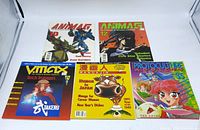 Front view of all five magazines showing cover art and titles