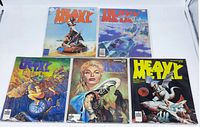 Five vintage Heavy Metal magazines arranged in two rows. All magazines are bagged and boarded showing vibrant cover art with sci-fi and fantasy themes from the 1970s.
