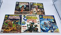 Five vintage Unknown Worlds of Science Fiction magazines displayed upright and arranged together showing detailed front covers with sci-fi themed colorful illustrations.