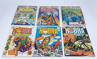 Six vintage Kobra comic books from DC Comics laid out in two rows of three, each comic individually bagged and boarded. Covers show classic comic art with the character Kobra in various action poses and scenes.