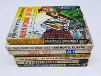 Stack of seven vintage science fiction paperback books showing spines and cover of When Worlds Collide.