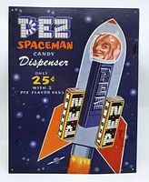 Front of tin PEZ sign featuring retro Spaceman candy dispenser design and price details.