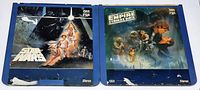 Front covers of two Star Wars LaserDiscs showing original Star Wars and The Empire Strikes Back artwork on blue sleeves.