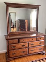 Frontal view of the maple dresser with mirror showing drawer arrangement and wood finish