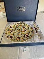 Boxed set containing a ceramic cake plate with fruit pattern and matching cake server inside satin-lined box.