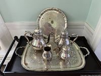 Full overview of the entire silver-plated tea set placed on the ornate serving tray showing all pieces and tray with engraved detailing