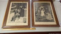 Two framed prints with flamed oak frames side by side with measuring ruler for scale, showing Victorian scenes with children and dogs.