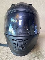 Front view of the black BILT motorcycle helmet showing the visor, ventilation, and BILT logo.
