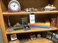 Wide view of wooden shelf showing timer, keys, crystal and upper items