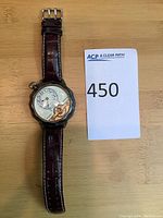 Full front view of watch and strap laid flat