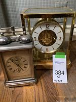 Both clocks side by side on wood surface