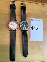 Both assembled watches side by side on wooden surface