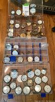 Three plastic compartment boxes filled with pocket watches, movements and keys