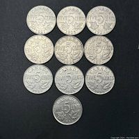 Top down view of all 10 Canadian five cent coins arranged to show date and design. Coins dated 1927 through 1936 visible, showing circulated condition with wear.