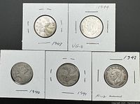 Five Canadian silver quarters from 1940 to 1944 styled in white cardboard coin holders, showing obverse and reverse details