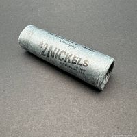 Full grey paper roll of $2 worth of Canadian nickels, wrapped and intact with slight loosening at the ends.