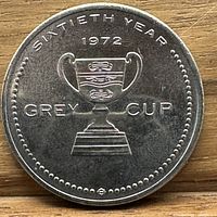 Obverse side of the 1972 Grey Cup token showing the trophy and text sixtieth year, 1972, Grey Cup.
