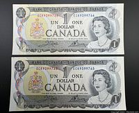 Two Canadian one dollar bills from 1973 laid flat showing front side with serial numbers ECK9399765 and ECK9399766