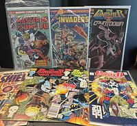 Photo showing six comic books from the lot including Master of Kung Fu, The Invaders, The Punisher, and S.H.I.E.L.D., arranged side by side with colorful, detailed covers.