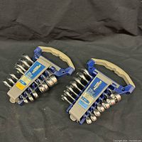 Two sets of chrome stubby combination wrenches in blue and gray plastic holders labeled Mastercraft MAXIMUM with handles, one SAE and one Metric.