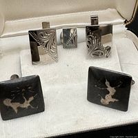 Close-up of the two pairs of cufflinks in a presentation box showing details of design and condition.