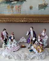 Front view of full porcelain figural group showing five Rococo-style figures on an ornate base
