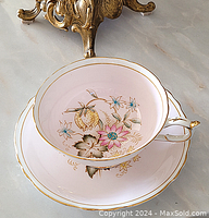 Top view of teacup inside saucer showing floral and gold detailing