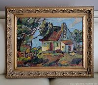 Full view of framed oil painting depicting house near water with trees under a blue sky, showing texture and colors.