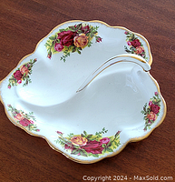 Top-down photo of the divided dish showing floral pattern and gold trim.