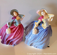Two Royal Doulton Autumn Breezes figurines side by side, showing their full standing poses and color differences.