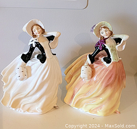Two Royal Doulton Autumn Breezes figurines side by side, showing full front and side details.