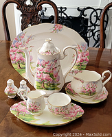 Group shot of all tea set components on wooden table.