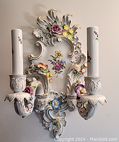 Front view of the ornate electrified German porcelain wall sconce with hand-painted and applied flowers, showing dual candle style light holders.