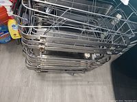 Stack of over seven metal wireframe racks for chafing dishes