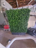 Artificial grass block wall panel approximately 3 feet tall, full front view showing leaf detail and black base.