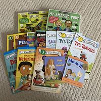 Photo of children's educational books, various titles including I Can Read! series and Little Explorers books on bugs and the human body.