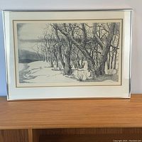 Front view of the framed artwork showing the winter landscape with numerous detailed trees and snow.