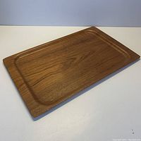 Top-down view of the rectangular wood tray showing uniform wood grain and smooth recessed center.