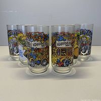 Full view of set of six vintage McDonald's Muppets glass cups arranged on table