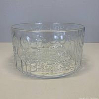 Front view of the clear glass bowl showing floral and dotted embossed patterns.