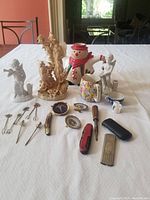 Overview of all pen tools and miniatures arranged on white cloth, showing variety and scale of items.