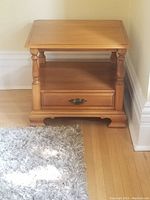 Front view of the Roxton maple bedside table showing the drawer and lower shelf