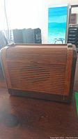 Front view of the wooden Philco radio showing slatted wood design and speaker area.