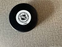 Bottom of the hockey puck showing official NHL licensing logo.