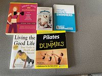 Photo showing five fitness books including Smart Girls Do Dumbbells and Pilates for Dummies among others.